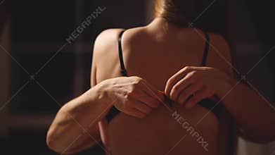 Boyfriend stretches and takes off girl`s bra while the are kissing and gently strokes her back making love. Seductive
