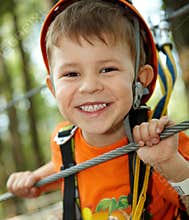 Little boy smiling in adventure park