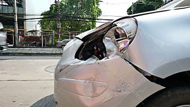 4K Car scratch on front bumper from accident with flashing emergency lights