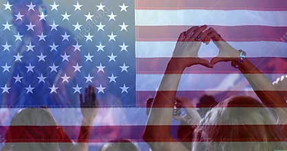 Crowd enjoying time at concert with American flag