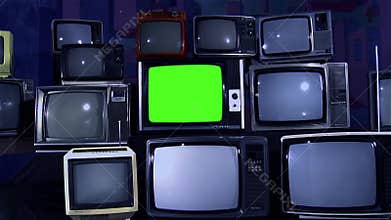 Retro tv turns on green screen in the middle of many tvs. Aesthetics of the 80s.