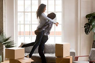 Happy african first time home buyers couple celebrating moving d