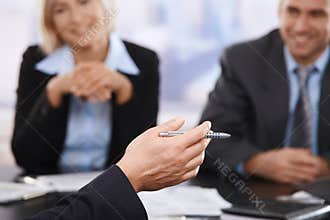 Business meeting, hand with pen in closeup