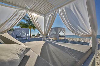 White beach canopies. Luxury beach tents at tropical resort, luxurious vacation and holiday concept t