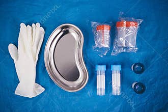 Fryazino, Russia - 06 11 2018: flat lay of disposable gloves, medical tray, containers for collecting urine and biomaterials