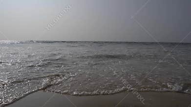 Waves crashing on seashore low angle