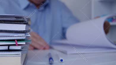 Workplace Image with Manager Browsing Financial Documents and Accounting Papers