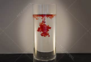 Red food coloring in water in a vase