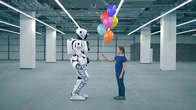 Concept of future. One girl presenting balloons to a droid, side view.