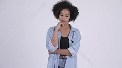Young serious African woman thinking and looking down
