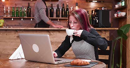 Zoom in shot on mature businesswoman in her 40s working on laptop