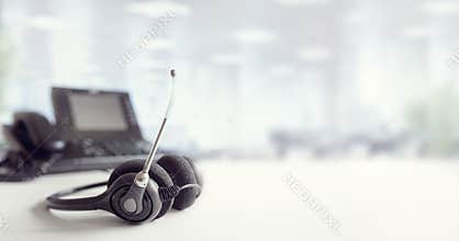 Headset headphones telephone on desk in call center