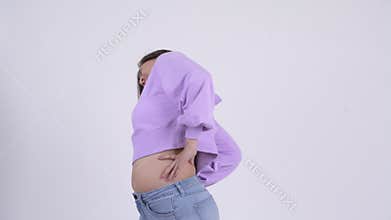 Young stressed Asian woman having back pain