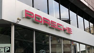 Porsche automobile dealership sign on building