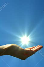 Hand sun and blue sky