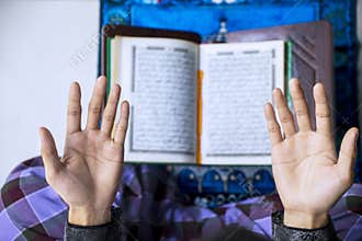 Young man hands praying to the Allah