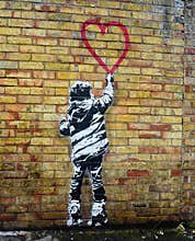 Banksy style stencil art. Child painting a heart shape