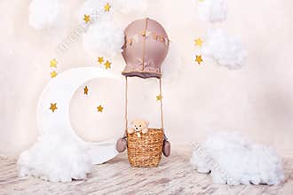 Teddy bear traveler and pilot. Childhood dreams. Stylish vintage children`s room with aerostat, balloons and textile clouds. Child