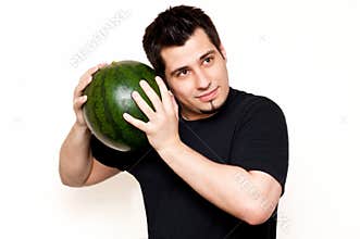 Guy checking watermelon for freshness