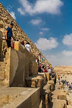 Tourists climbing the pyramids of Giza, Egypt
