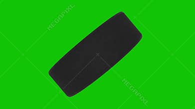 Animation of a hockey puck spinning on a green screen. Loop, 4K