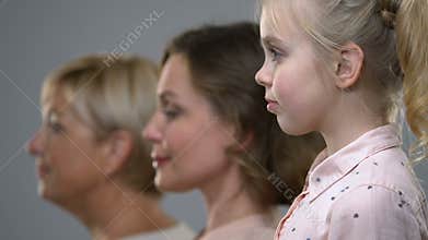 Side portrait of three female generations, birthrate and population ageing