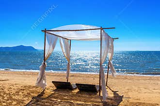 Beach canopies with sun loungers on beach