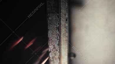 Human hand coming from dark and holding the wooden door.