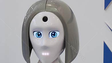 Turning head of robot with woman`s face.