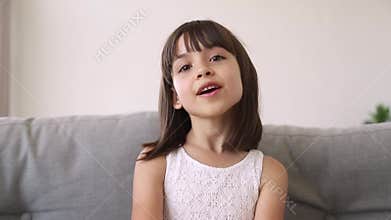 Little girl talking looking at camera making videocall recording vlog