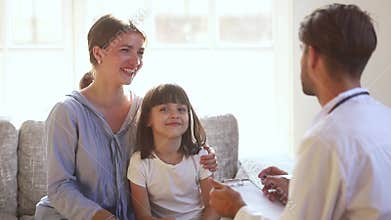 Kid patient sit on couch with mom talking to doctor