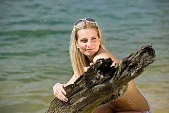 Beautiful woman enjoy summer sun at lakeside