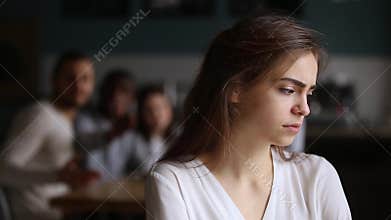 Sad offended teen ignoring friends apologizing for bad joke