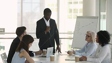 African boss coach manager leading speaking at corporate group meeting
