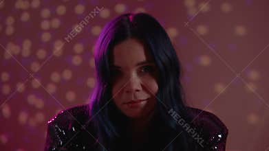Sleepy intoxicated or drunk girl looking at camera, feeling sick at club party