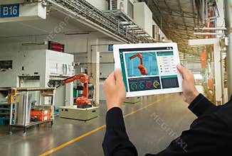 Iot industry 4.0 concept,industrial engineer using software augmented, virtual reality in tablet to monitoring machine in real t
