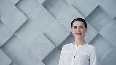 Beautiful brunette turning into camera and smiling