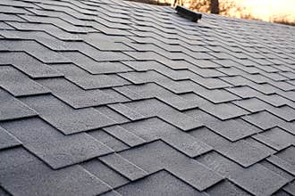 Close up view on Asphalt Roofing Shingles Background. Roof Shingles - Roofing. Shingles roof damage covered with frost.