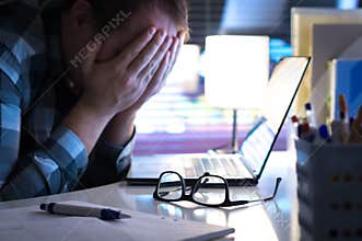 Problems at work. Sad, unhappy and tired man covering face.