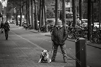 Man and his dog, street portrait, similar posture