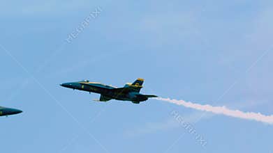 Blue angel streaks across sky turns into barrel roll