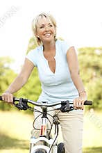 Portrait of mature woman riding cycle in countrysi