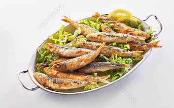 Crisp fried sardines in batter on fresh lettuce