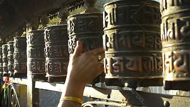 Spinning prayer wheels at the Swayambhunath Stupa, Kathmandu, Nepal.