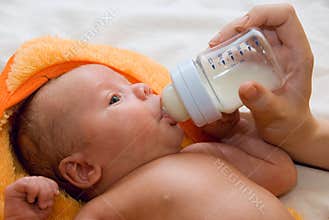 Baby boy and feeding bottle