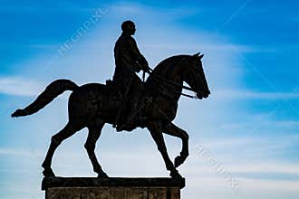 Equestrian monument on pedestal in backlight