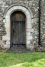 Architectural view of a very old timber door at the side of a famous castle.