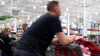 Motion of cashier scanning food and stocking them on trolley at check out counter