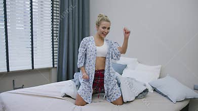 Pretty woman having fun on bed