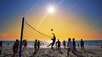 Playing beach volleyball